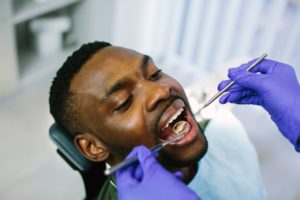 a man getting his dental cleaning by his dentist